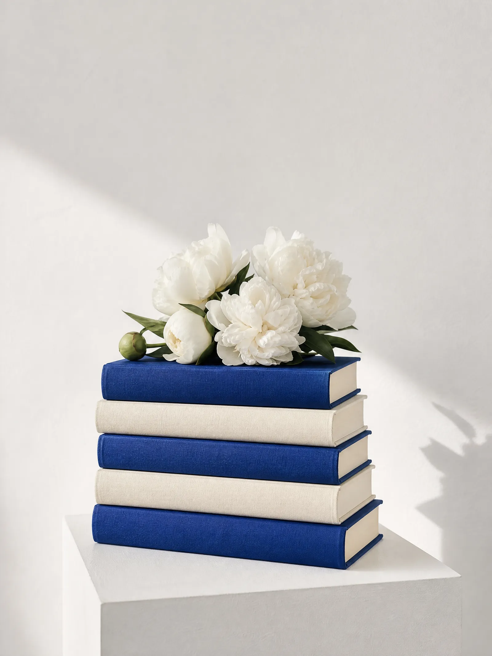 Cloth-bound books with white peonies